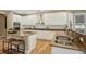 Bright, open kitchen with white cabinets, stainless steel appliances, and a large island at 1290 S Milwaukee St, Denver, CO 80210
