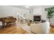 Elegant living room with fireplace, piano, hardwood flooring, and neutral decor at 1290 S Milwaukee St, Denver, CO 80210