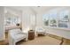 Open-concept room featuring an ensuite, hardwood floors, and large windows with stylish plantation shutters at 1290 S Milwaukee St, Denver, CO 80210