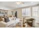 Inviting living room with large windows, hardwood floors, and comfortable furnishings at 1290 S Milwaukee St, Denver, CO 80210