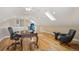Stylish home office is enhanced by hardwood floors, a skylight, and classic desk creating an inspiring workspace at 1290 S Milwaukee St, Denver, CO 80210