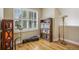 Bright office features a large window, a bookcase, and hardwood floors creating an inviting workspace at 1290 S Milwaukee St, Denver, CO 80210