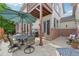 Paver patio features an outdoor dining area with comfortable seating, a grill, and lush greenery at 1290 S Milwaukee St, Denver, CO 80210