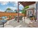 Stone patio with an outdoor dining area, a grill, and a manicured garden, perfect for entertaining at 1290 S Milwaukee St, Denver, CO 80210