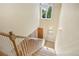 Bright entryway staircase featuring wood steps, white railing, and natural light at 1290 S Milwaukee St, Denver, CO 80210