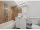 Bathroom featuring a shower-tub combo with nice tiling and a single sink vanity at 7550 Raleigh St, Westminster, CO 80030