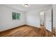 Bright bedroom with hardwood floors and a doorway leading to an en suite bathroom at 7550 Raleigh St, Westminster, CO 80030