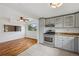 Kitchen and dining area boasts granite countertops, tile floor and stainless steel appliances at 7550 Raleigh St, Westminster, CO 80030