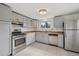 Well-equipped kitchen features stainless steel appliances, granite countertops and tile flooring at 7550 Raleigh St, Westminster, CO 80030
