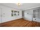 Bright living room featuring wood floors, a large window and charming built-in shelving at 7550 Raleigh St, Westminster, CO 80030