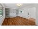 Bright living room featuring hardwood floors, custom built-ins, and arched doorways at 7550 Raleigh St, Westminster, CO 80030