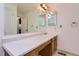 Spacious bathroom vanity area with large mirror, bright lighting, and practical storage at 6755 S Field St # 606, Littleton, CO 80128