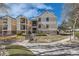 Apartment exterior featuring well-manicured landscaping, stone accents, and private balcony at 6755 S Field St # 606, Littleton, CO 80128