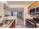 Well-lit kitchen with modern stainless steel appliances and a seamless view into the cozy living area at 6755 S Field St # 606, Littleton, CO 80128