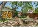 Charming backyard with a patio set, beautiful landscaping, and mature trees offering plenty of shade at 3010 Zinnia Ct, Golden, CO 80401