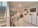 Finished basement area featuring a pinball machine, storage, and carpeted stairs at 3010 Zinnia Ct, Golden, CO 80401