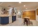 Basement boasts a unique wet bar with wooden countertop and ample lighting at 3010 Zinnia Ct, Golden, CO 80401