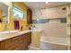 Bright, cheerful bathroom featuring updated fixtures, a vessel sink, and modern tile work at 3010 Zinnia Ct, Golden, CO 80401
