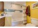 Bright bathroom with tiled walls, shower with curtain, and decorative art at 3010 Zinnia Ct, Golden, CO 80401