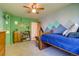 Cozy bedroom with mountain mural, neutral carpet, and natural light at 3010 Zinnia Ct, Golden, CO 80401