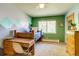 Comfortable bedroom features mountain-themed wall, ample natural light, and classic furnishings at 3010 Zinnia Ct, Golden, CO 80401