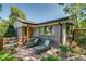 Inviting front yard features a brick exterior, cozy seating, and lush landscaping at 3010 Zinnia Ct, Golden, CO 80401