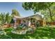 Charming home with a well-maintained front yard, lush lawn, and a cozy seating area at 3010 Zinnia Ct, Golden, CO 80401