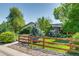 Landscaped front yard with wood and wire fence, gravel, and a variety of trees and bushes at 3010 Zinnia Ct, Golden, CO 80401