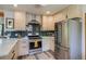 Modern kitchen boasts stainless steel appliances, sleek light cabinets, and attractive backsplash at 3010 Zinnia Ct, Golden, CO 80401