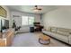 Comfortable living room offers a cozy couch, large window, and sleek ceiling fan at 3010 Zinnia Ct, Golden, CO 80401