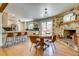 Spacious dining and living area with stone fireplace and modern kitchen at 3010 Zinnia Ct, Golden, CO 80401