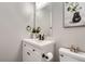 Stylish bathroom featuring a modern vanity with black hardware, framed mirror, and toilet at 690 Howe Ct, Castle Rock, CO 80104
