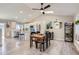 Light and airy dining area with a wooden table and a view into the modern kitchen at 690 Howe Ct, Castle Rock, CO 80104