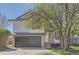 Charming home featuring a two-car garage and well-manicured landscaping with an inviting front entrance at 690 Howe Ct, Castle Rock, CO 80104