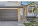 Exterior shot highlighting front door, garage, steps, and partial front yard with lawn at 690 Howe Ct, Castle Rock, CO 80104