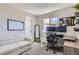 Bright home office with large window, desk setup, comfortable seating, and ample natural light at 690 Howe Ct, Castle Rock, CO 80104