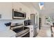 A well-equipped kitchen with stainless steel appliances, white cabinets, and a modern subway tile backsplash at 690 Howe Ct, Castle Rock, CO 80104