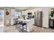 Updated kitchen featuring white cabinets, stainless steel appliances, and a spacious center island at 690 Howe Ct, Castle Rock, CO 80104