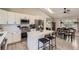 Modern kitchen flows to the dining area, featuring sleek appliances and a sunlit space at 690 Howe Ct, Castle Rock, CO 80104