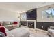 Cozy living room with fireplace, mounted TV, and comfortable sectional sofa at 690 Howe Ct, Castle Rock, CO 80104