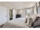 Main bedroom with en-suite bathroom featuring a sliding barn door entrance and an abundance of natural light from the large window at 690 Howe Ct, Castle Rock, CO 80104