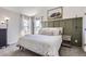 Relaxing main bedroom with modern decor, serene wall art, and soft natural light streaming in from the two windows at 690 Howe Ct, Castle Rock, CO 80104