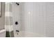 Clean bathroom shower showcasing white subway tile, modern black fixtures, and a stylish shower curtain at 690 Howe Ct, Castle Rock, CO 80104