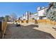 Townhome backyard featuring private fenced yards with patios and shared lawn on a sunny day at 2594 E Nichols Cir, Centennial, CO 80122