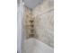 Bathroom featuring a tiled shower and corner shelves at 2594 E Nichols Cir, Centennial, CO 80122