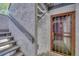 Close-up of the condo's entrance showing a secure screen door and a flight of stairs at 6420 S Dayton St # J07, Englewood, CO 80111