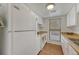 Functional kitchen with white appliances, ample counter space, and a window view at 6420 S Dayton St # J07, Englewood, CO 80111
