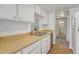 Bright kitchen showcasing a double sink, wood countertops, and efficient cabinet storage at 6420 S Dayton St # J07, Englewood, CO 80111