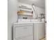 Convenient laundry area equipped with a washer, dryer, and storage shelves at 6420 S Dayton St # J07, Englewood, CO 80111