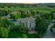 Majestic aerial view of a beautiful home with lush landscaping, in a serene, tree-filled neighborhood setting at 291 Fairchild Dr, Highlands Ranch, CO 80126
